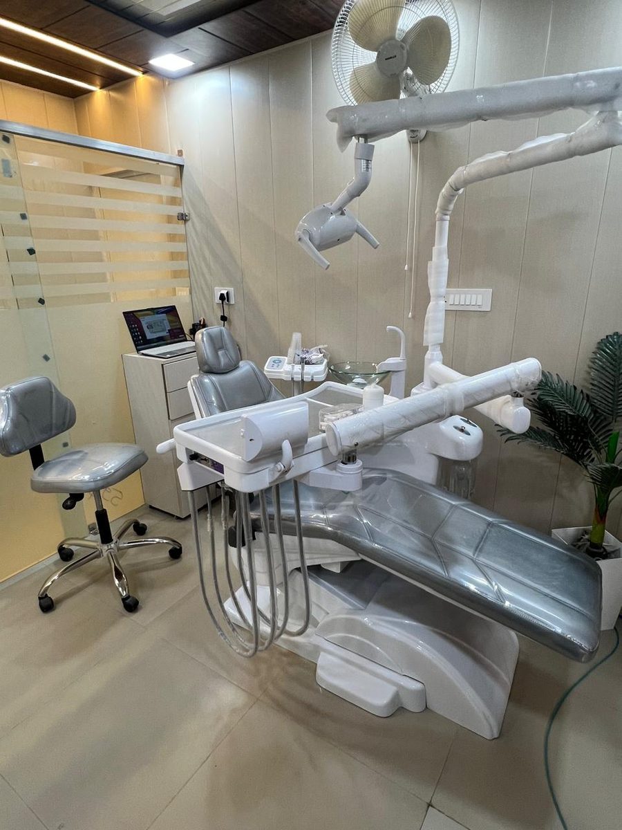 A CareWell treatment room with dental chair, overhead light and operator stool